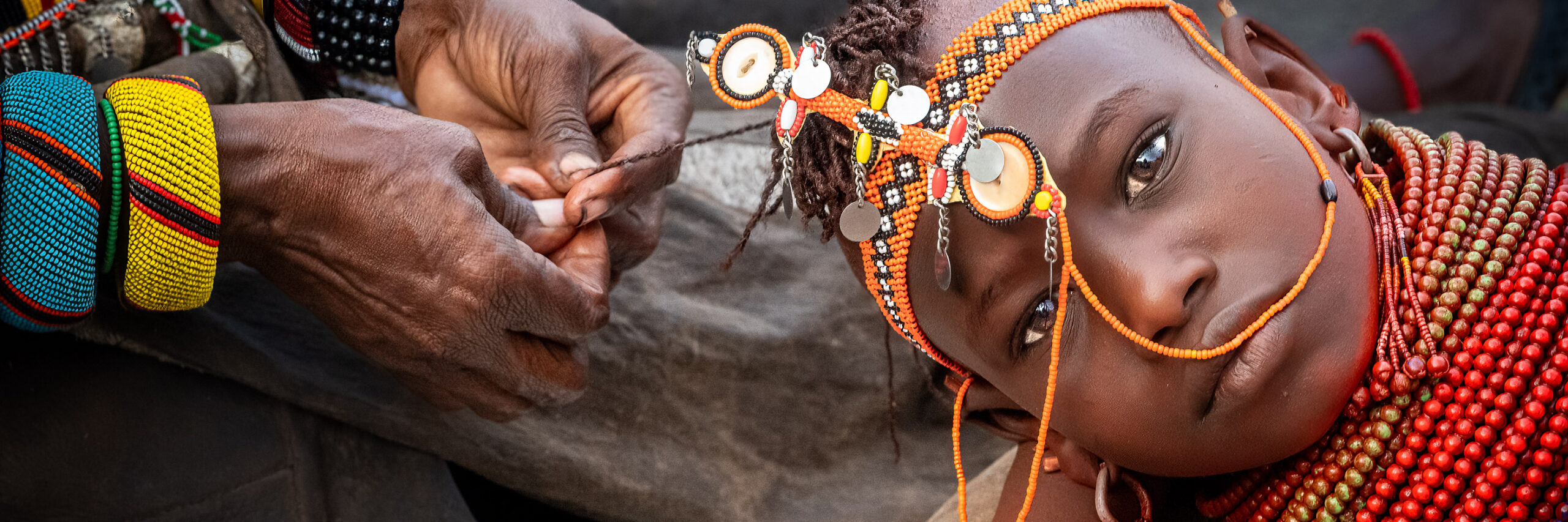Samburu woman having her hair braided, northern Kenya