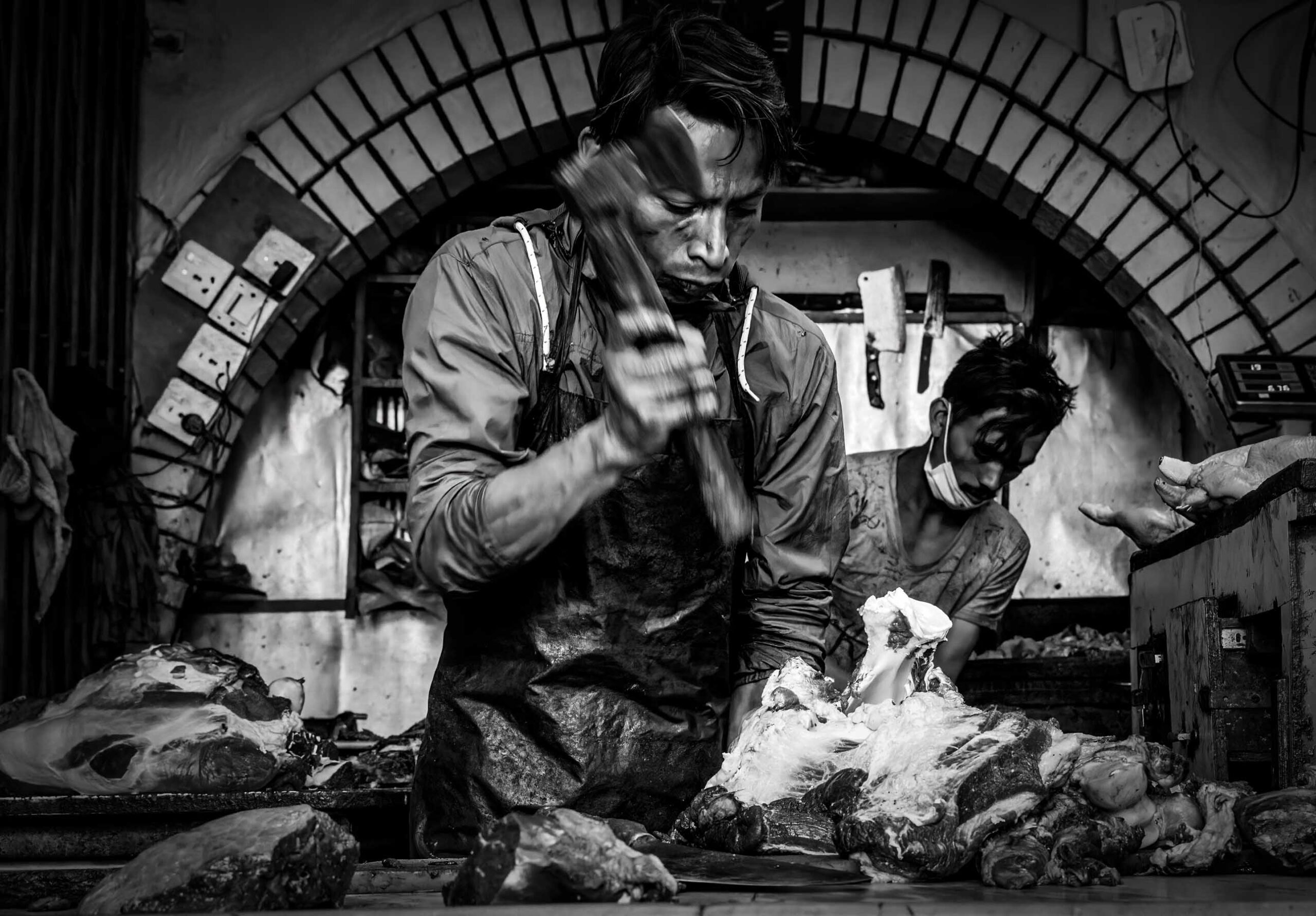 Butcher at work in a market, Nepal