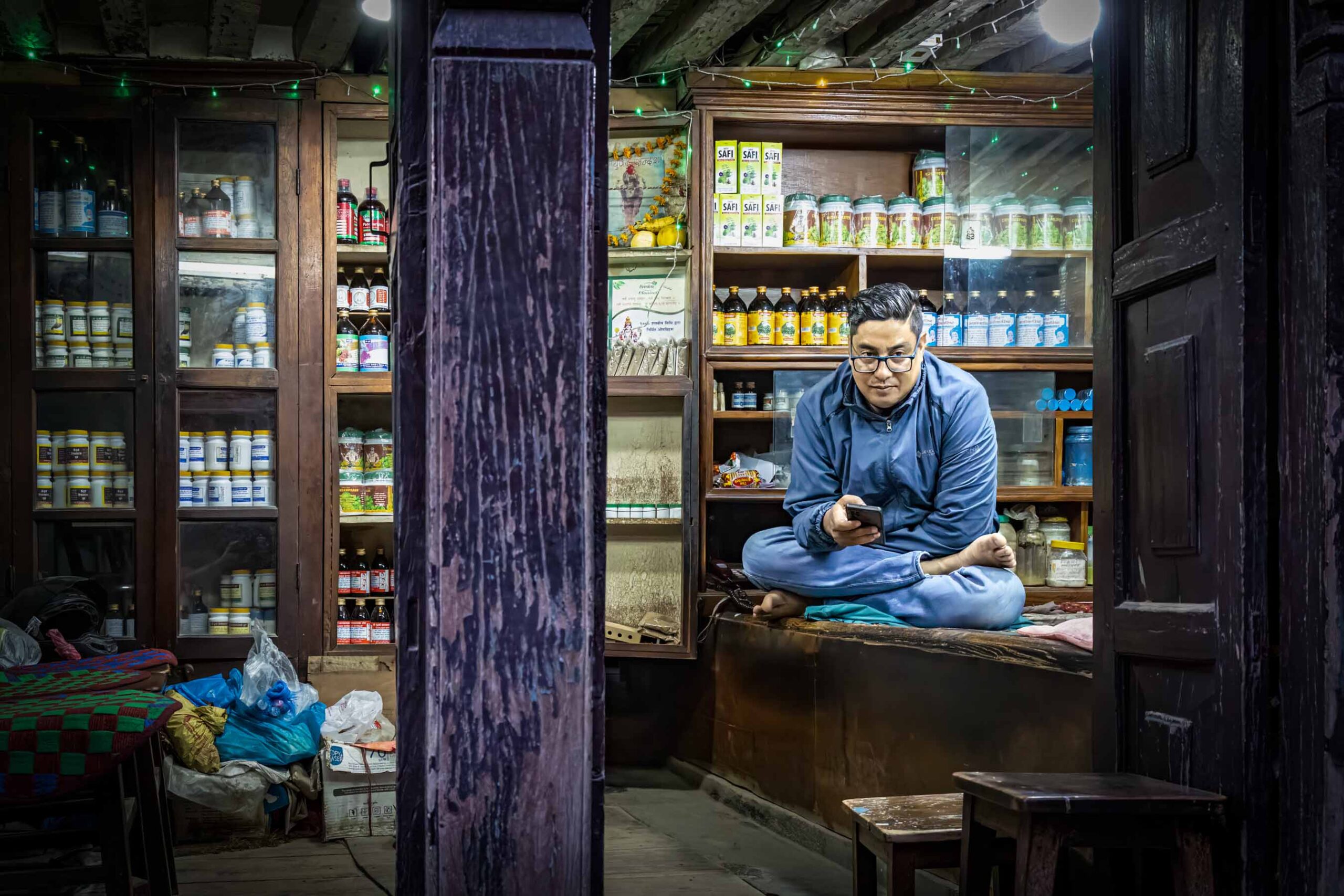 Shopkeeper sitting inside his shop, Nepal