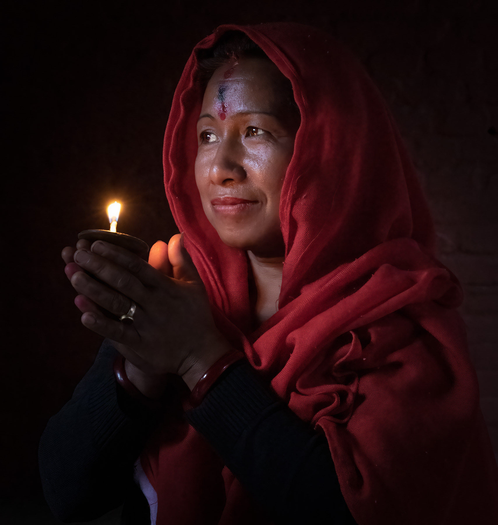 Woman holding an oil lamp, Nepal