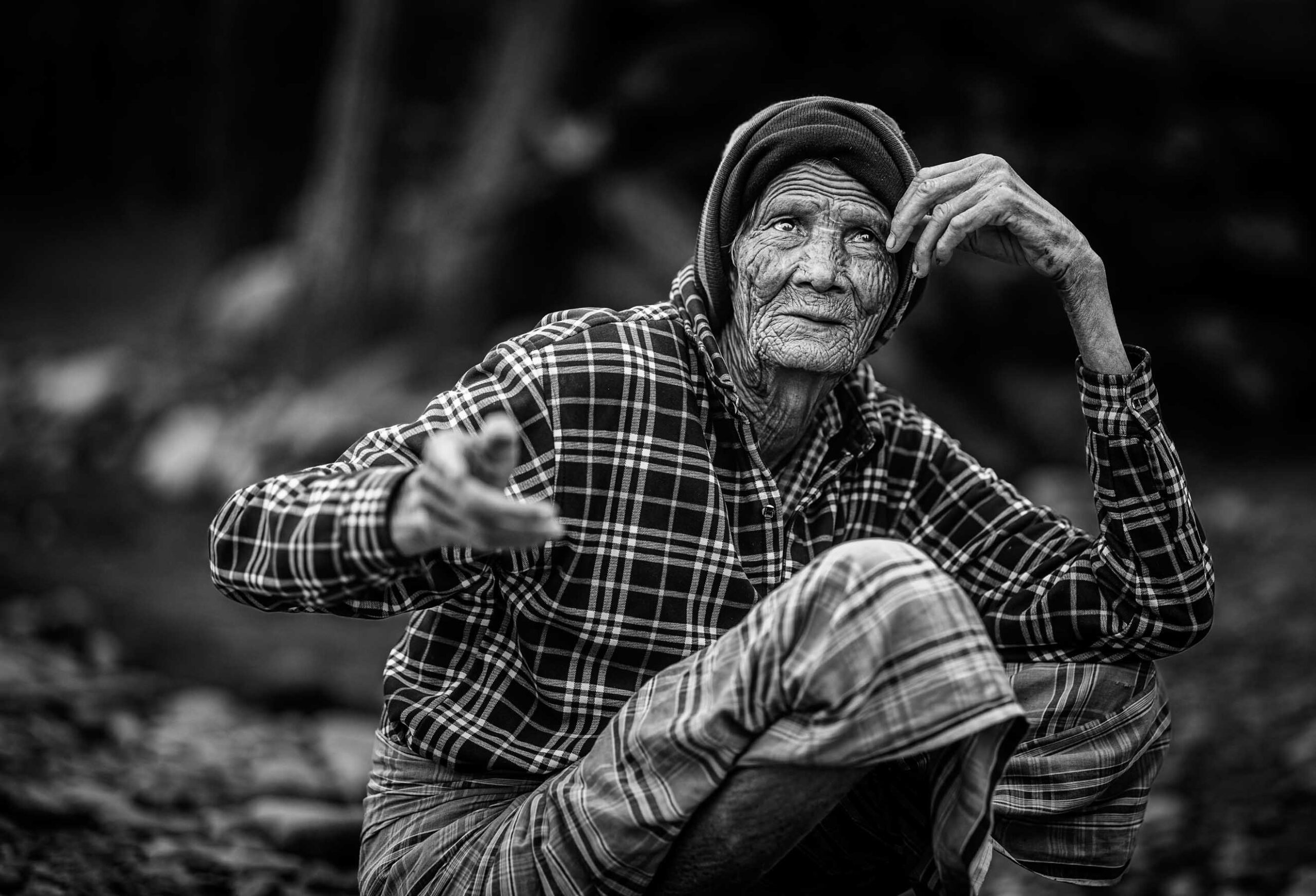 Older man sitting by a stream, Nepal