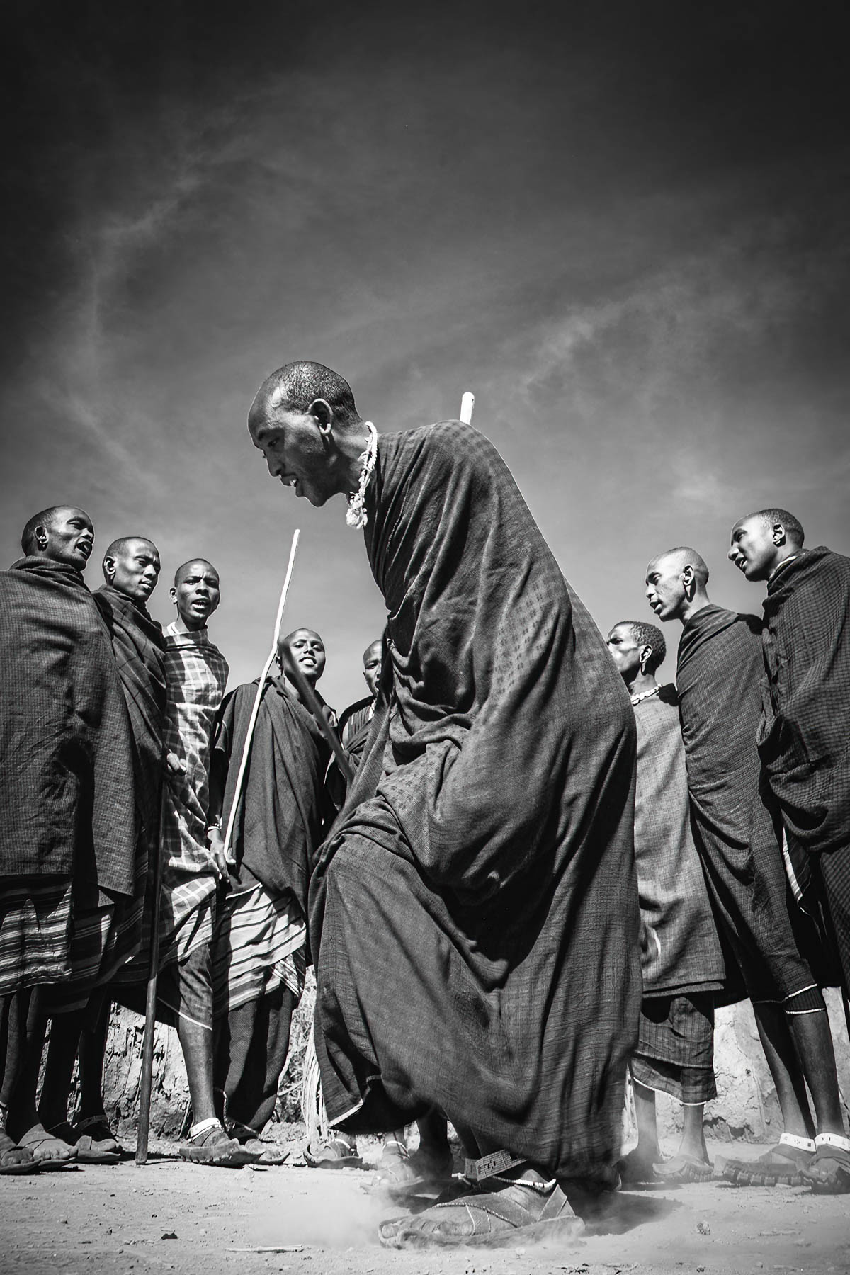 Elder dancing with a group of Maasai men, Tanzania