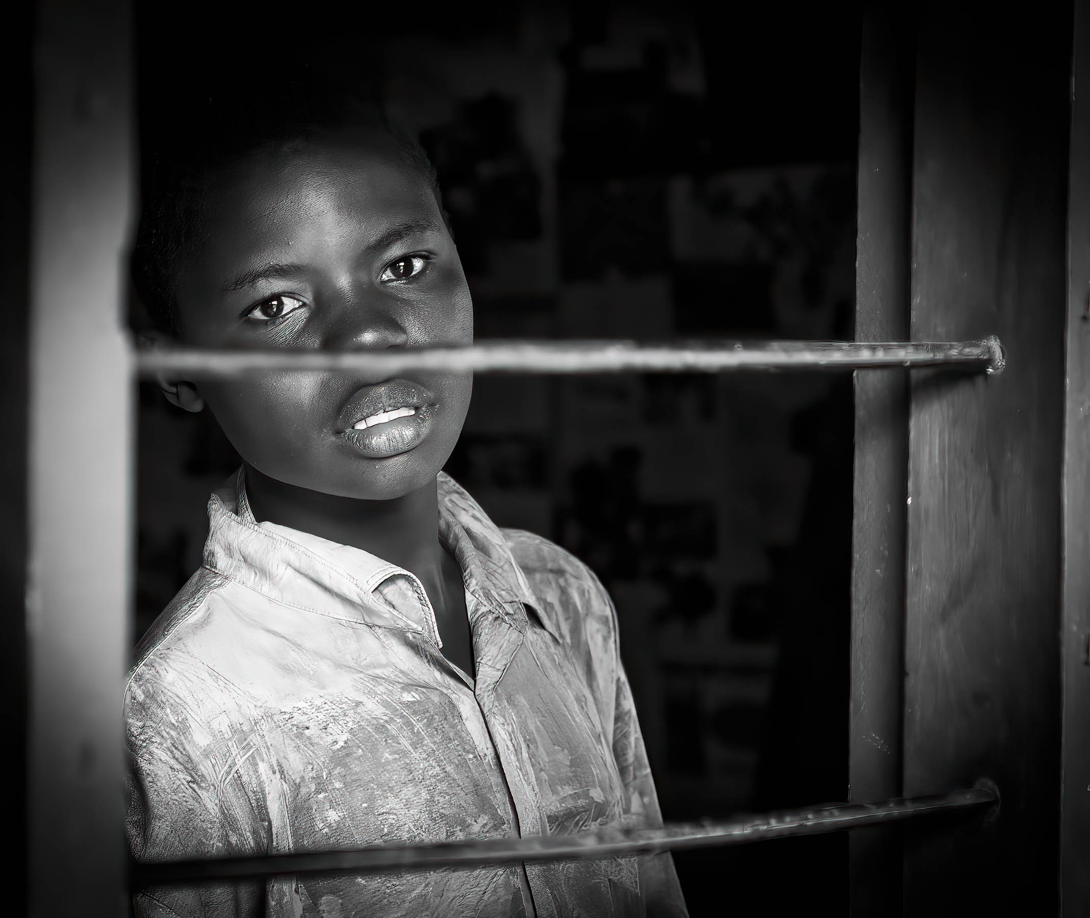 Boy behind a doorframe, Tanzania