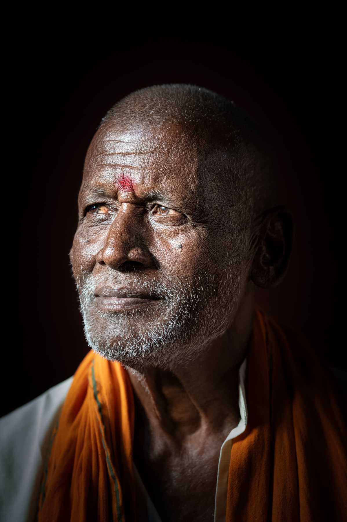 Portrait of an elderly man in orange, Nepal